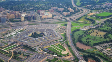 Aerial view of the United States Pentagon, the Department of Defense headquarters in Arlington, Virginia, near Washington DC, with I-395 freeway and the Air Force Memorial and Arlington Cemetery nearby.