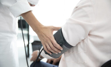 Measuring the pressure of senior woman