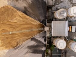 Aerial view/Cement mixing plant where cement is being mixed in cement trucks to the construction site.