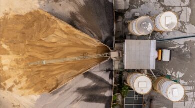 Aerial view/Cement mixing plant where cement is being mixed in cement trucks to the construction site.