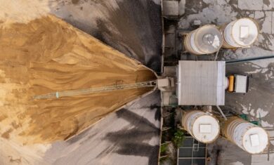 Aerial view/Cement mixing plant where cement is being mixed in cement trucks to the construction site.