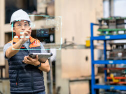 Japanese males engineer working on digital tablet and digitalization display in automated production line. He had development performance for use in automated machine. Production improvement concepts.