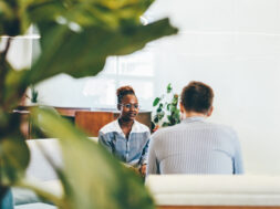 Businessman talking during an interview with a businesswoman. Colleagues discussing business.