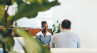 Businessman talking during an interview with a businesswoman. Colleagues discussing business.