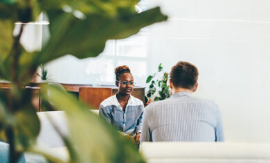 Businessman talking during an interview with a businesswoman. Colleagues discussing business.
