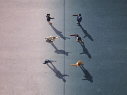 Businesspeople stretching towards each other, on painted asphalt