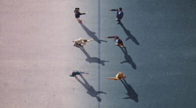 Businesspeople stretching towards each other, on painted asphalt