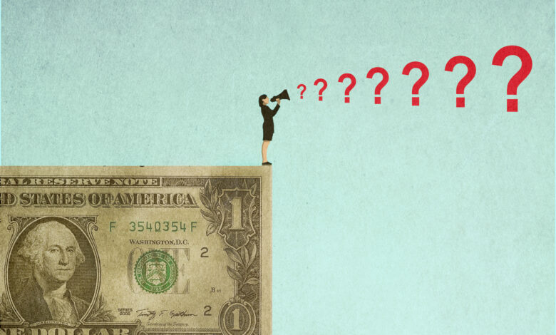 Businesswoman standing on oversized dollar and shouting questions through megaphone