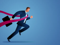 Businessman crossing finish line
