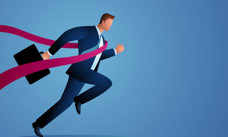 Businessman crossing finish line