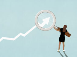 Woman holding magnifying glass over ascending graph arrow on blue background