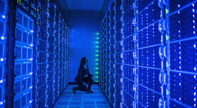 Side view of woman working in illuminated server room