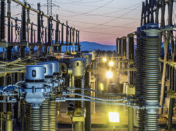 Detail of the infrastructure of an electrical substation illuminated at sunset.