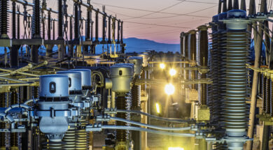 Detail of the infrastructure of an electrical substation illuminated at sunset.