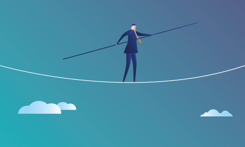 Business man walks on the wire rope
