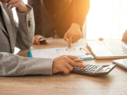 Two business people calculate their business in the office.
