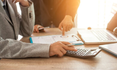 Two business people calculate their business in the office.